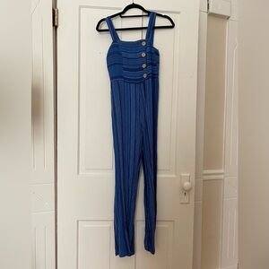 Navy blue jumpsuit with brown buttons